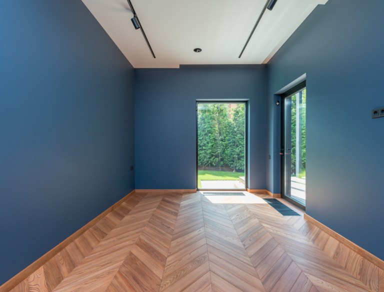 Intérieur d'une salle avec des murs bleus et d'un parquet bois.