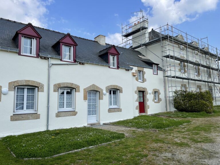 Grand angle d'une maison avec une façade blanche.